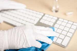 GXB Gebäudereinigung Biedenkopf hand-with-gloves-cleaning-a-keyboard-with-disinfectant.jpg
